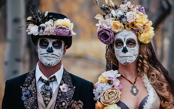 Man and woman in Dia De Los Muertos face paint